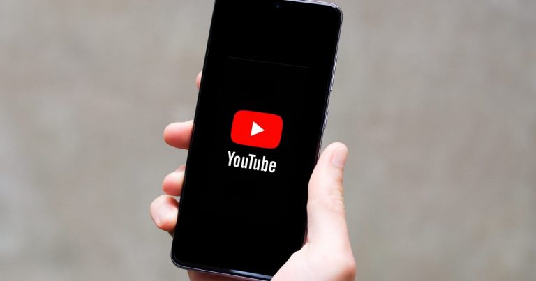 Phone-in-hand-showing-YouTube-logo