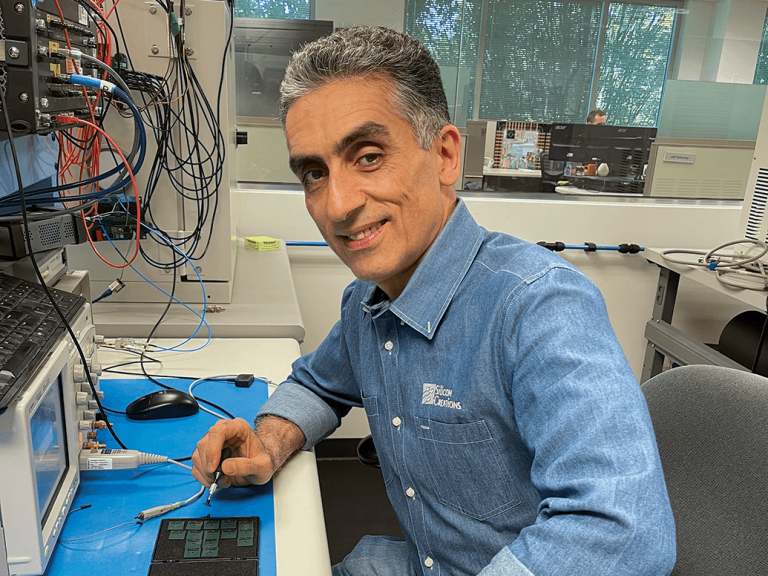 engineer-testing-electronic-components-at-a-lab-bench-with-cables-and-equipment